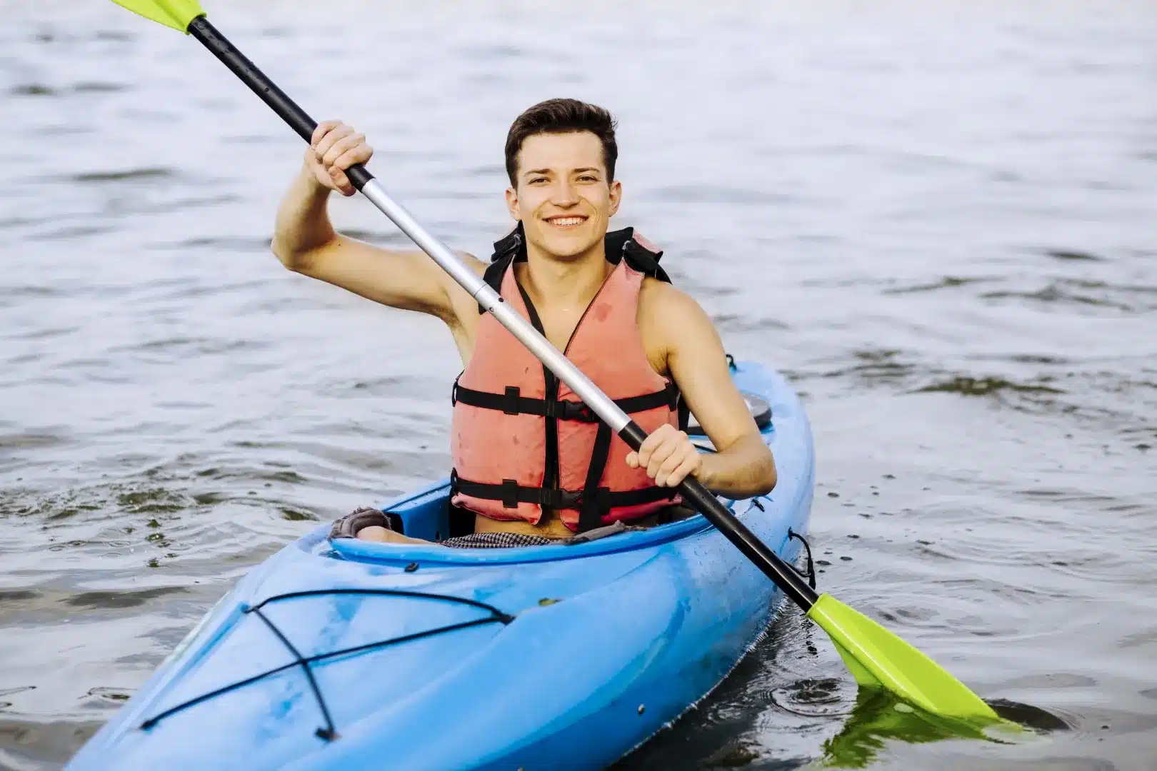 A person wearing a life jacket on a kayak