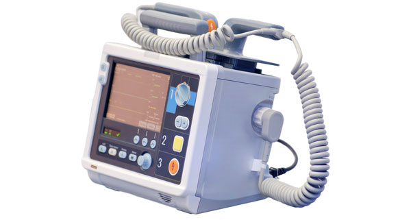 Automated external defibrillator (AED) device with monitor and paddles, used for emergency cardiac response and life-saving first aid treatment.